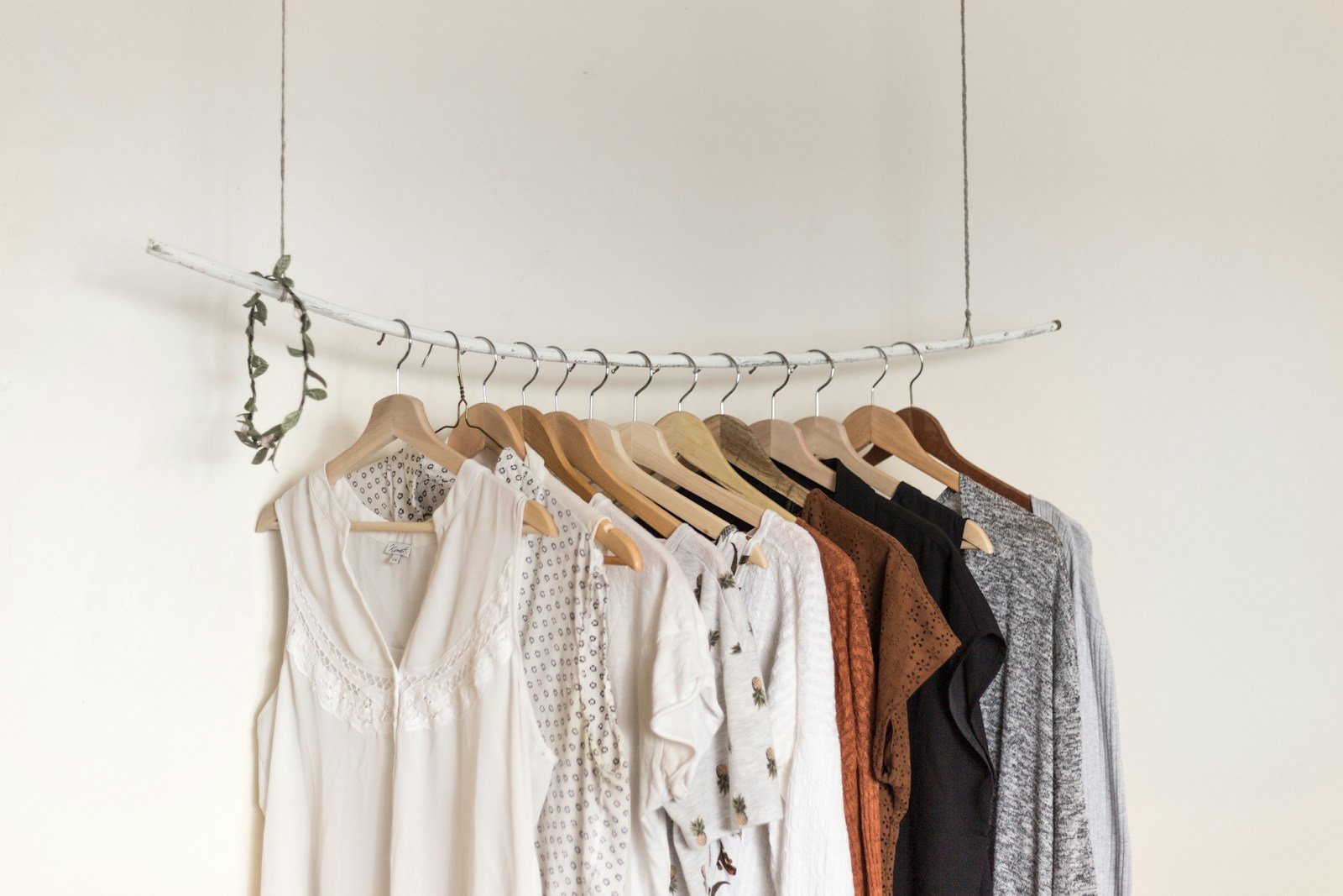 A light womenswear collection arranged on a studio rail